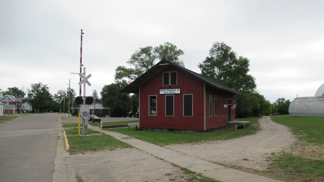 The red historic train depot in West Branch, Michigan